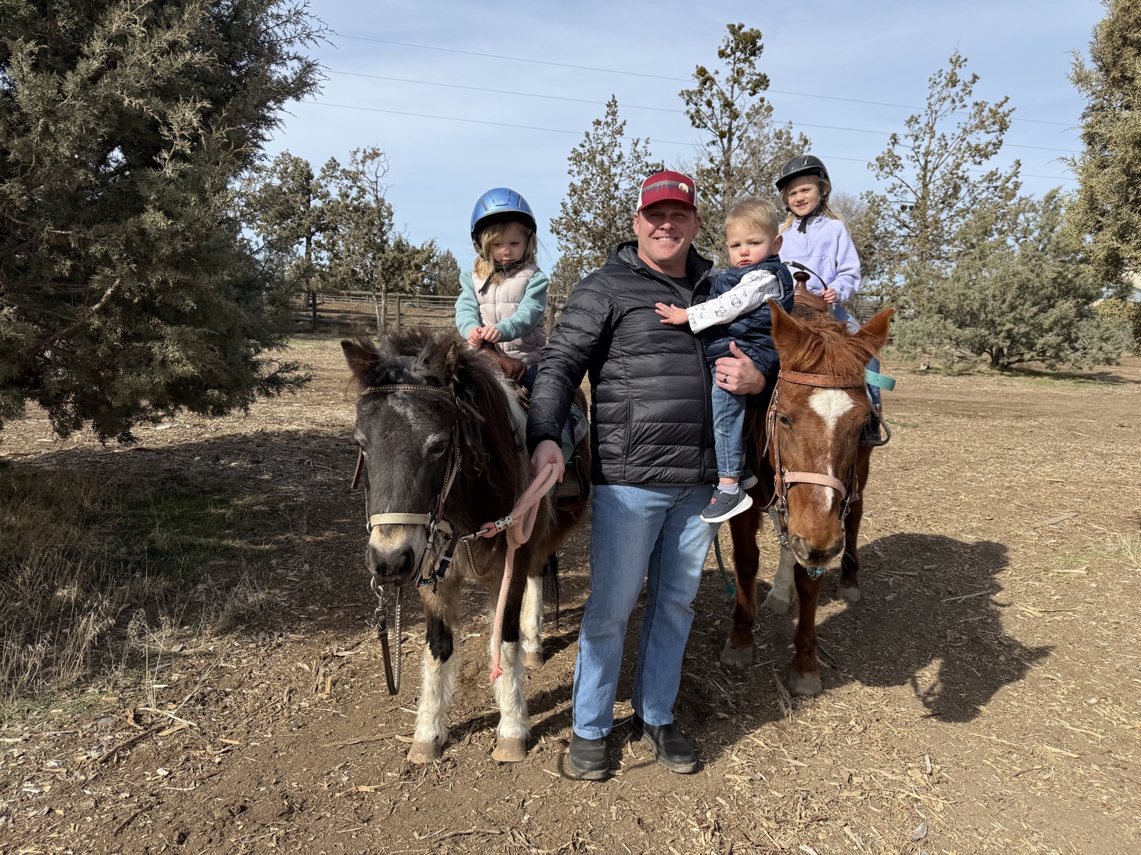 Brett with his daughters on a pony ride
